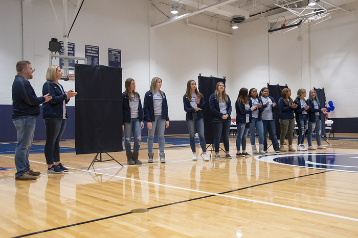 The 2019 Women's Volleyball team at the championship banner unveiling.
