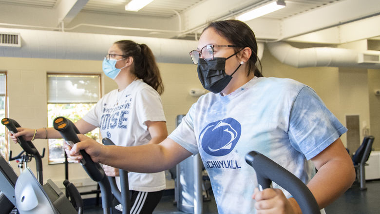 Two Penn State Schuylkill students using the new elliptical fitness equipment