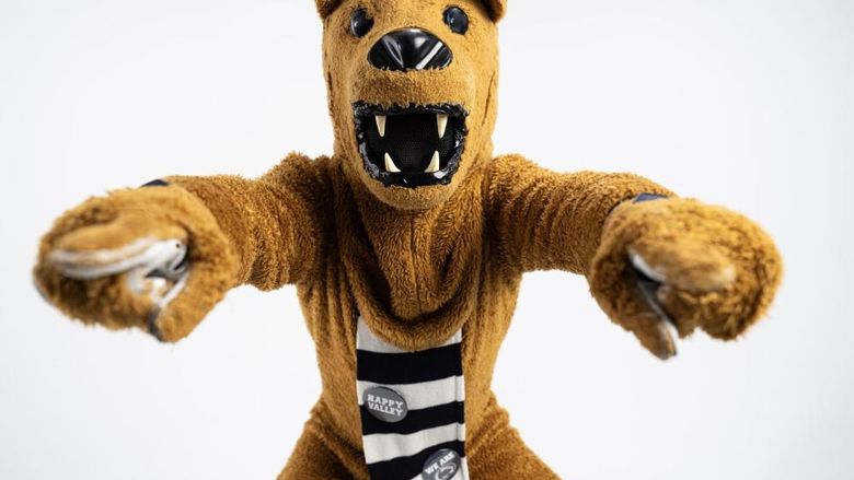 The Nittany Lion points to the camera with both hands