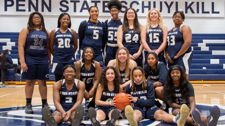 The Penn State Schuylkill women's basketball team poses at mid-court in the gymnasium.