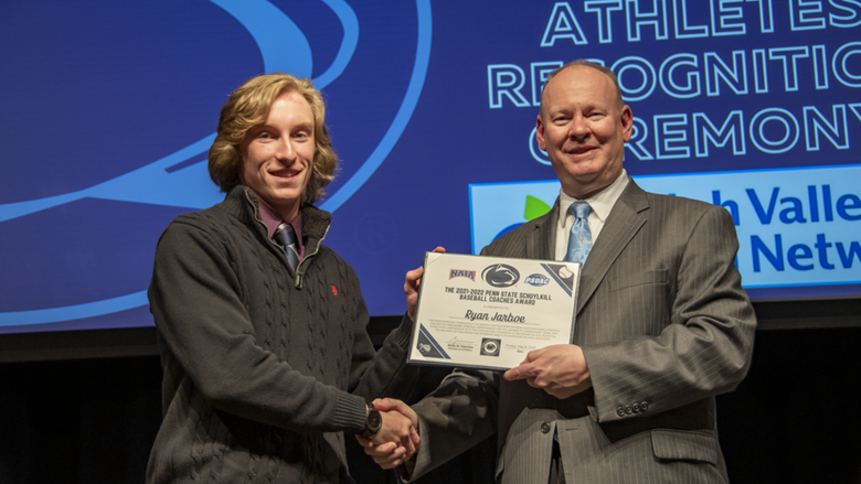 A male student-athlete receives award.