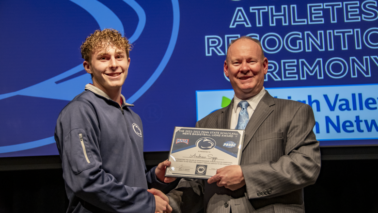 A male student-athlete receives award.