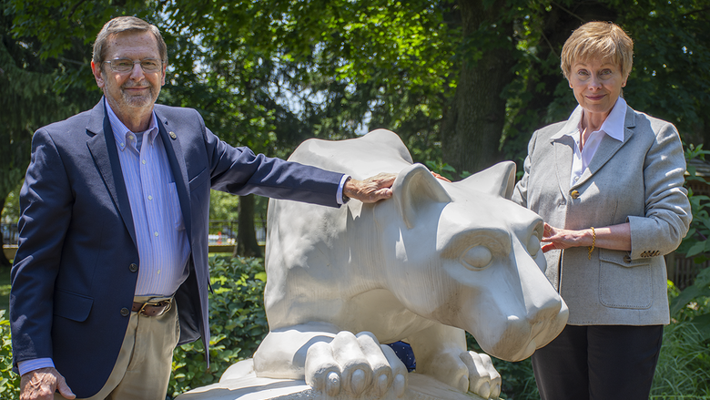 Former Penn State Schuylkill physics professor Dr. Michael Cardamone and his wife, Barbara, pose by Penn State Schuylkill's lion shrine.