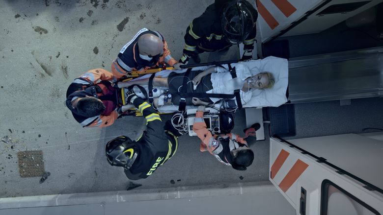 First responders lift and overdose victim into the back of an ambulance