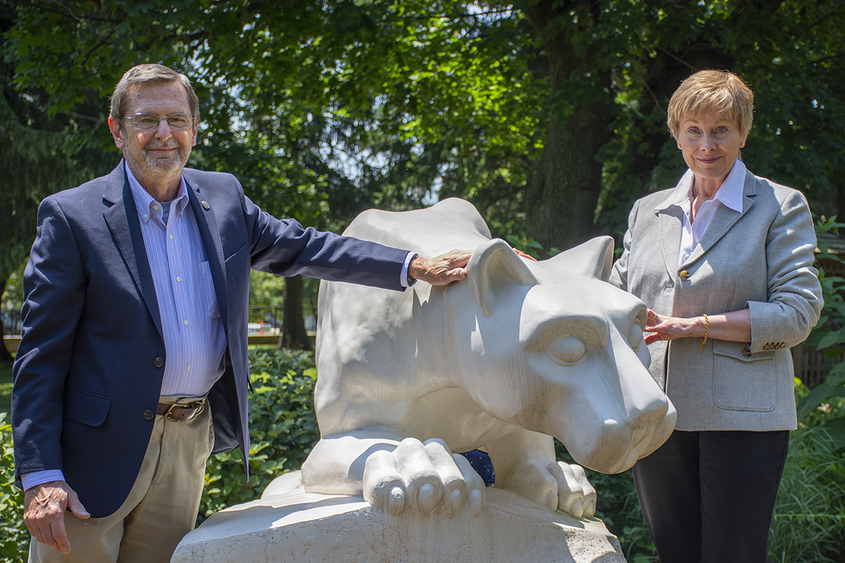 Former Penn State Schuylkill physics professor Dr. Michael Cardamone and his wife, Barbara, pose by Penn State Schuylkill's lion shrine.
