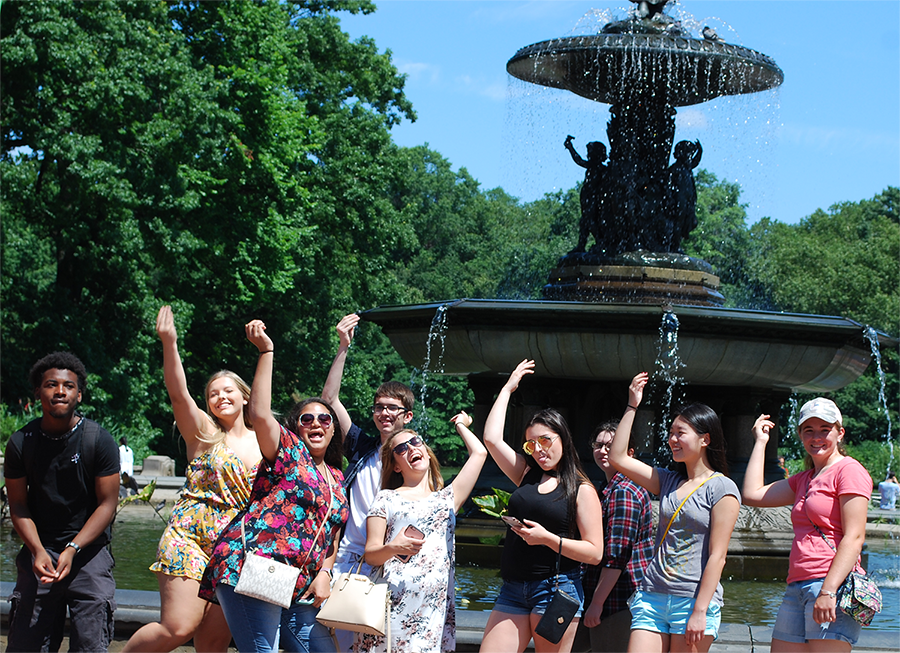 Freshman students pose in front of the New York City fountain that is famous to the opening of the sitcom Friends