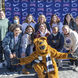 Group of smiling girls pose for a photo in front of a blue background with Penn State Athletics and NAIA logos.