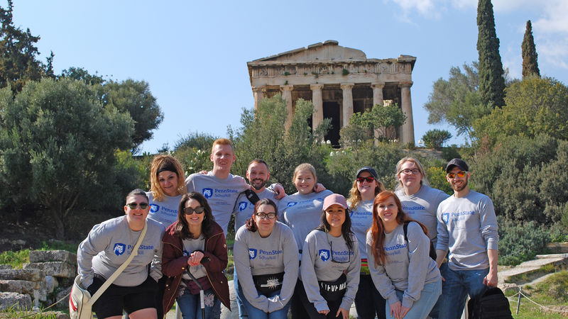 Penn State Schuylkill students pose for a photo in front of ancient Greek ruins.