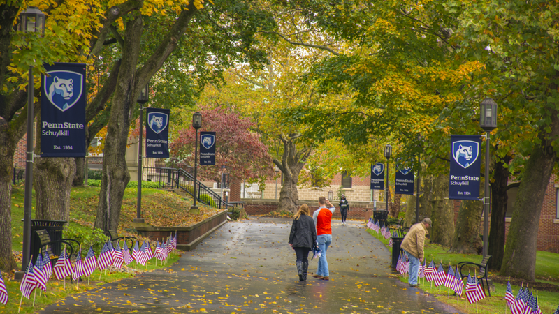 Students walk along Schuylkill mall walk after some midday autumn rainfall.