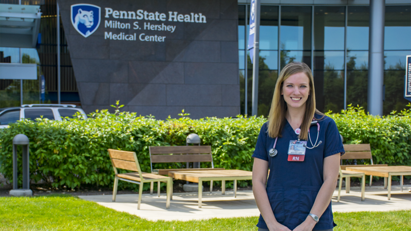 Anastasia Barnhardt poses in front of Penn State Health Milton S. Hershey Hospital.