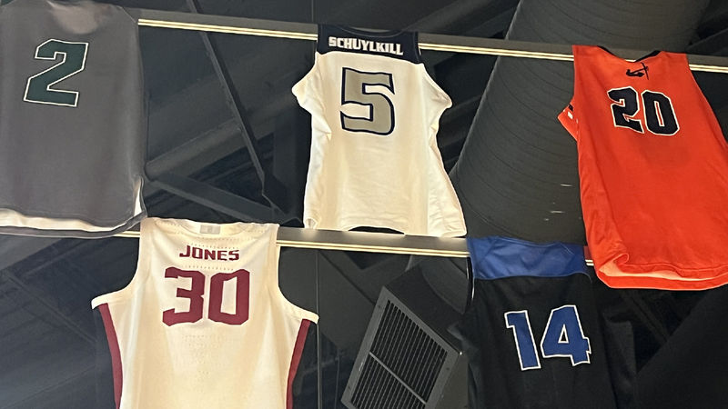 Basketball jerseys hanging form rafters in Hall of Fame