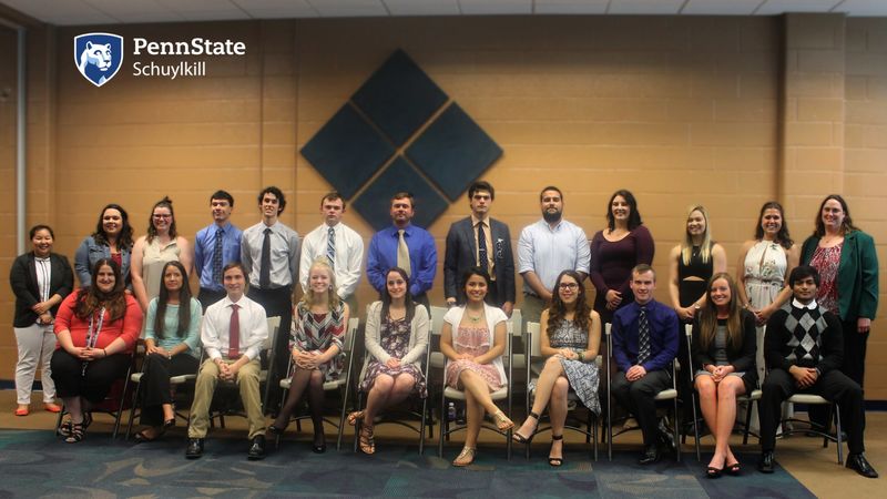 A group of students, faculty and staff pose for a photo after being inducted into Beta Beta Beta, the National Biological Honors Society.