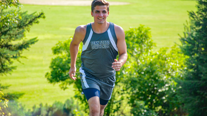 Penn State Schuylkill athlete Nico Granito warms up for a cross country match.
