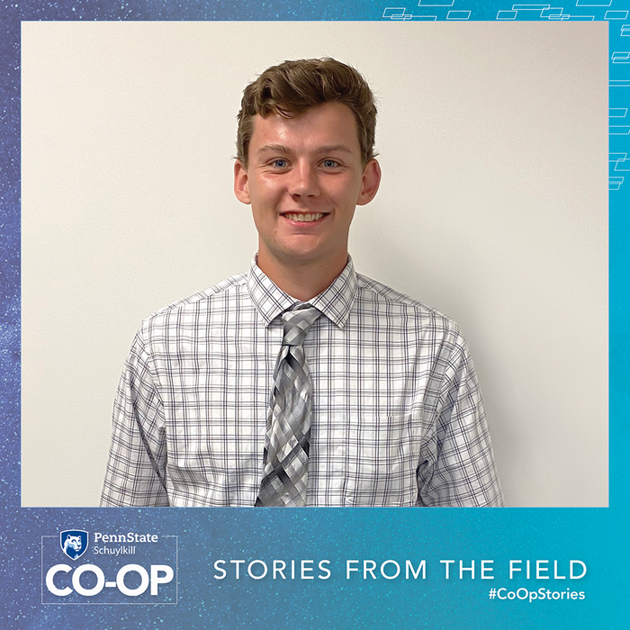 Co-Op intern Sean Duffy posed against a white office wall.