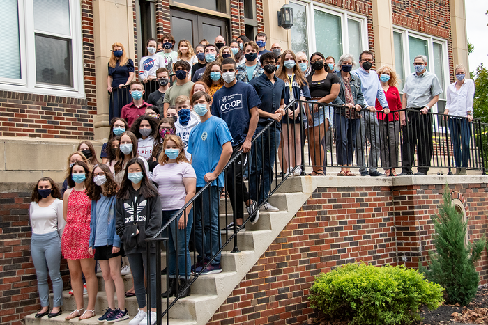 An image of masked Honors Program students and faculty on the stairs of the Classroom Building