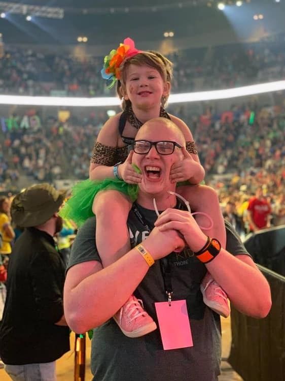 Eric Thompson stands at the Bryce Jordan Center with THON kid Devon Pulaski on his shoulders during THON weekend