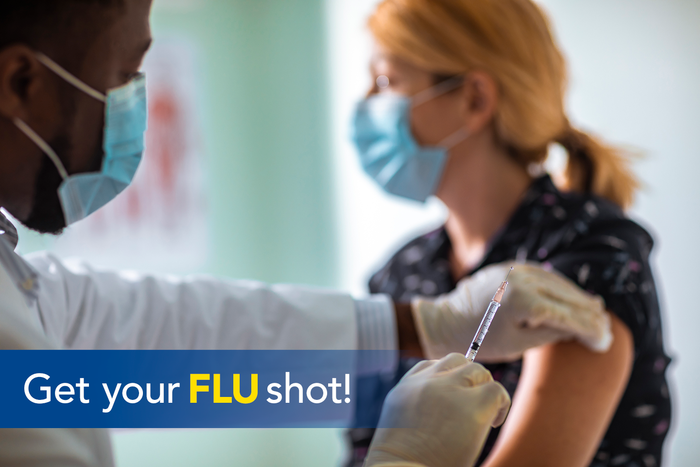 A college student receives a flu vaccination from a medical professional.