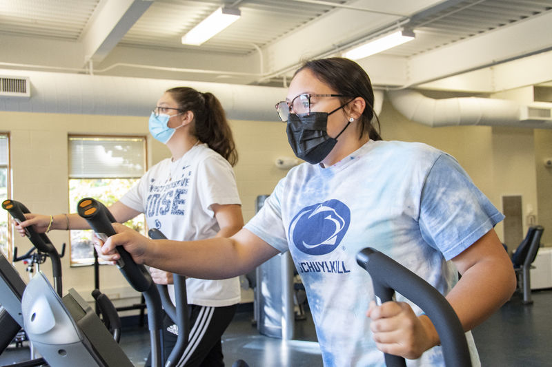 Two Penn State Schuylkill students using the new elliptical fitness equipment
