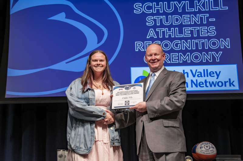 A female student-athlete receives award.