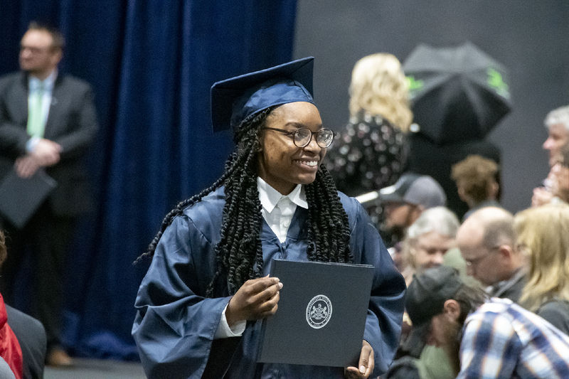 A student holds diploma.