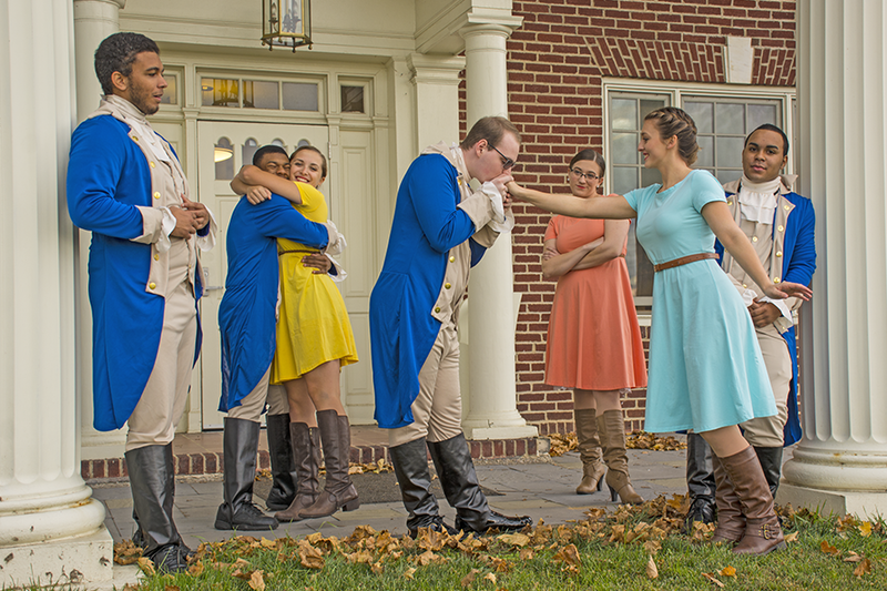 Seven students stand in front of Schuylkill's Kiefer-Jones Building, dressed in theatre production costume.