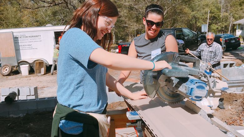 Two women working with Habitat for Humanity