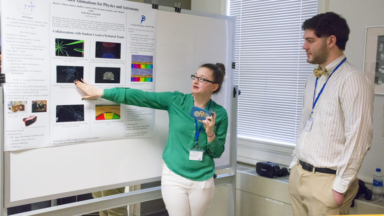 During a research poster session at a Physics Conference, Kelsey Shaffer demonstrates a lightning fractal effect in 3D by using a smartphone. 