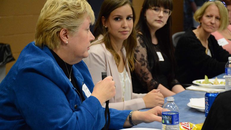 Barbara Miller, local business leader, talks to student at prior luncheon