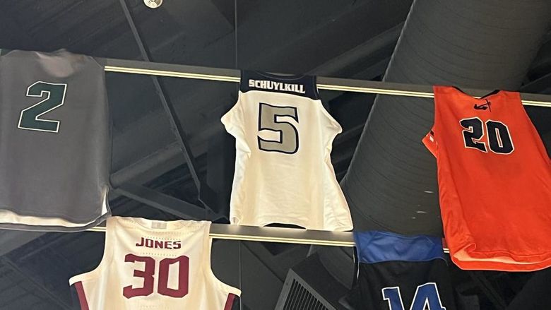 Basketball jerseys hanging form rafters in Hall of Fame
