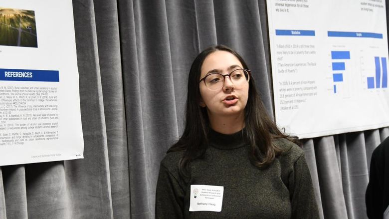 Female student presents research at conference