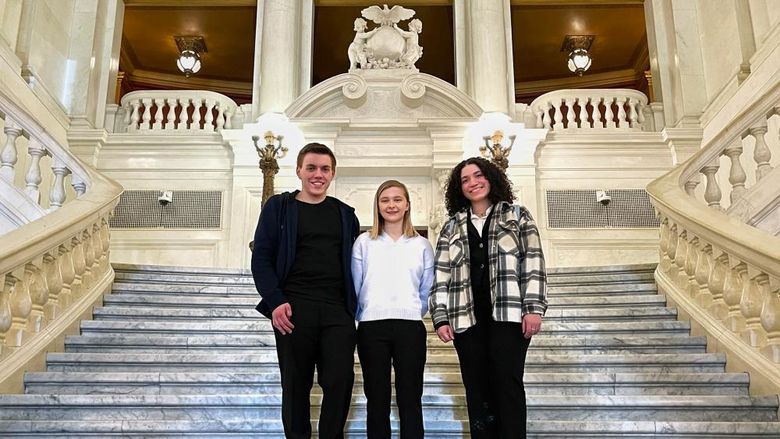 Three undergraduate research students on the Capitol steps