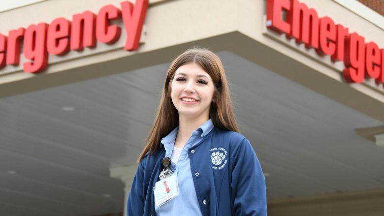 Radiological Science student smiling outside of healthcare facility