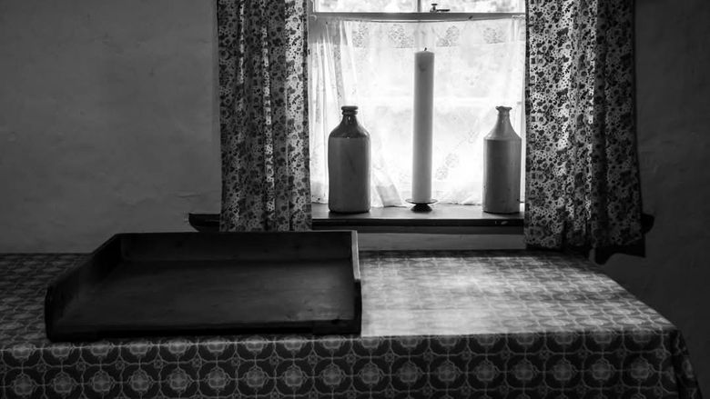 black and white photo of a table and window