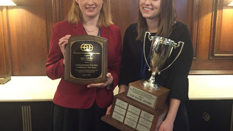 Dr. Valerie Schrader and student holding trophies