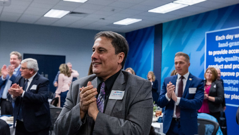 Attendees applaud at the Business Executive Forum