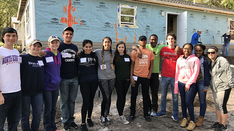 Group of students in front of house