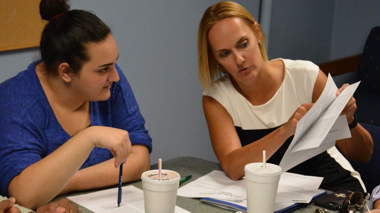 ESTEEM student Leila Duka and mentor Kim Lorimer work together during a class round table discussion.