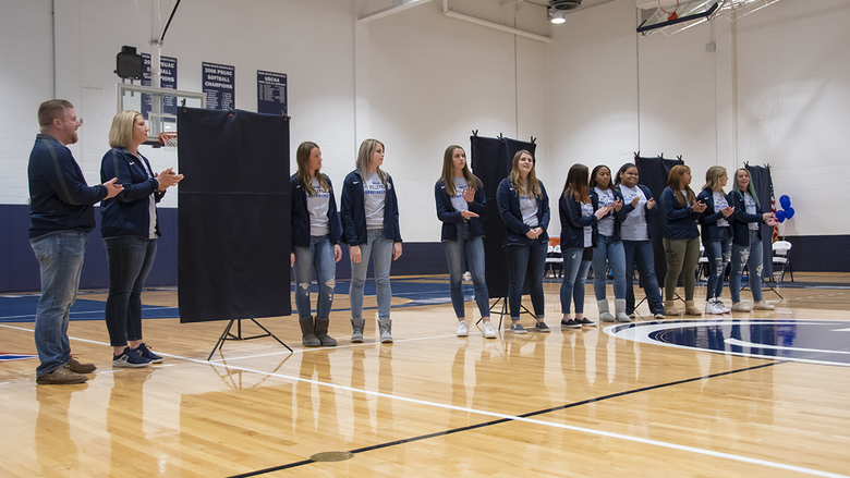 The 2019 Women's Volleyball team at the championship banner unveiling.