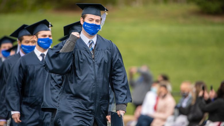 Penn State Behrend graduates celebrate as they leave the stadium at the conclusion of an outdoor ceremony on May 8.