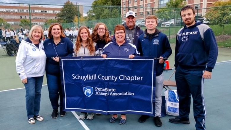 An image of members of the Schuylkill County Chapter with their parade banner.