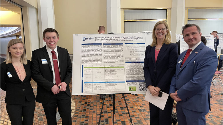Students Justice Cappella and Zakkary Hozella pictured with faculty mentor and a poster on an easel