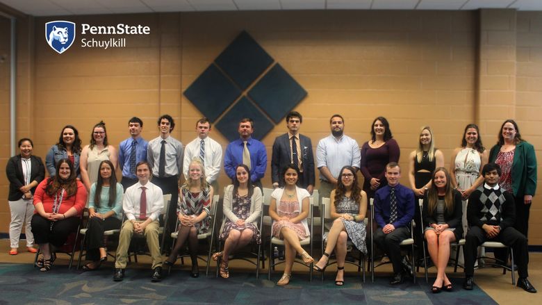 A group of students, faculty and staff pose for a photo after being inducted into Beta Beta Beta, the National Biological Honors Society.