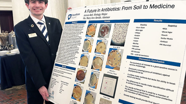 James Bell next to his poster