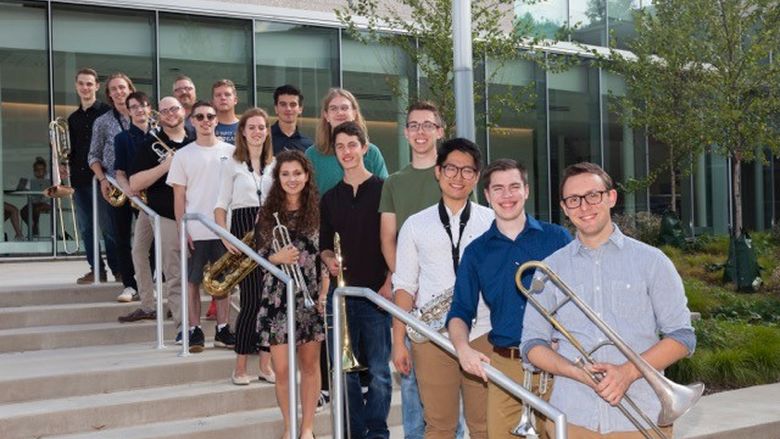 members of the Centre Dimensions jazz ensemble pose for a photo outside of a building