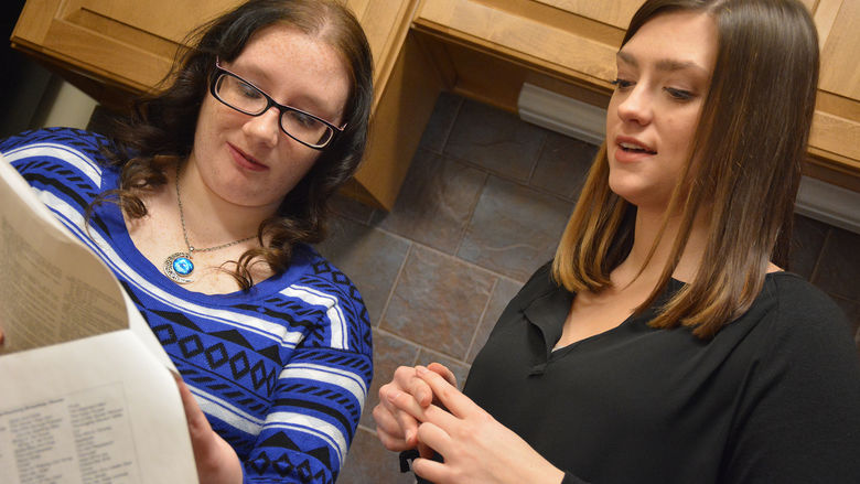 Brenna and Julia look over their papers to prepare for the conference
