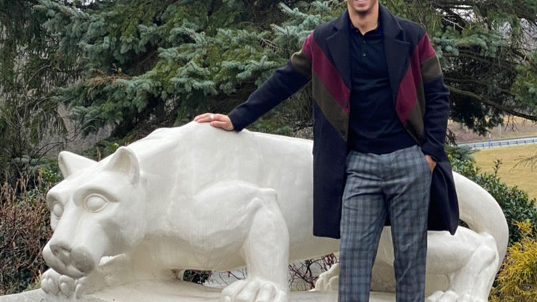 Male standing outside next the Nittany Lion Shrine
