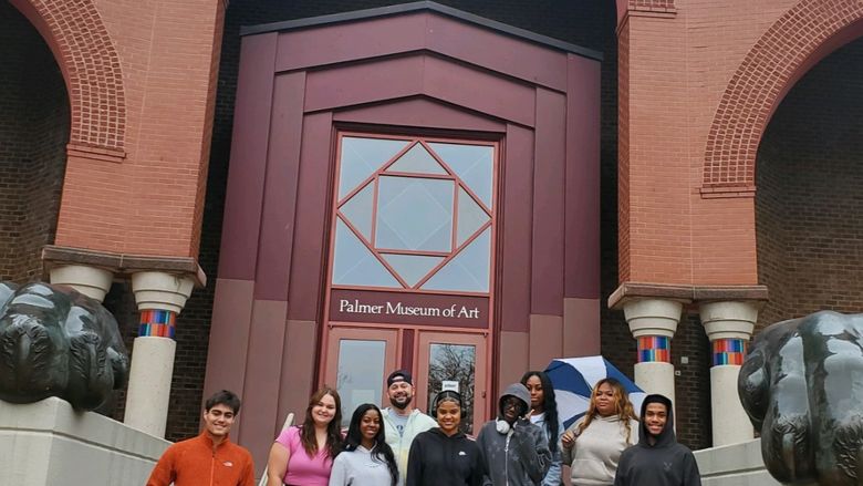 group people standing in front of a museum