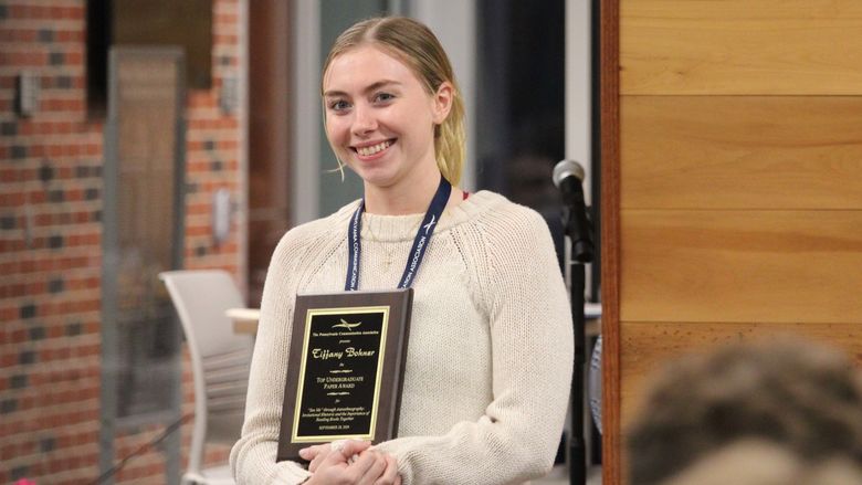Tiffany Bohner receiving the award for the Top Undergraduate Student Paper