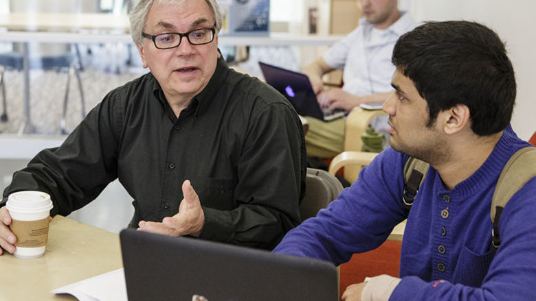 A professor speaks to a student at Penn State Berks
