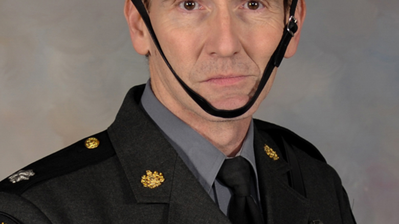 A head shot of Scott Price in his formal State Police uniform.